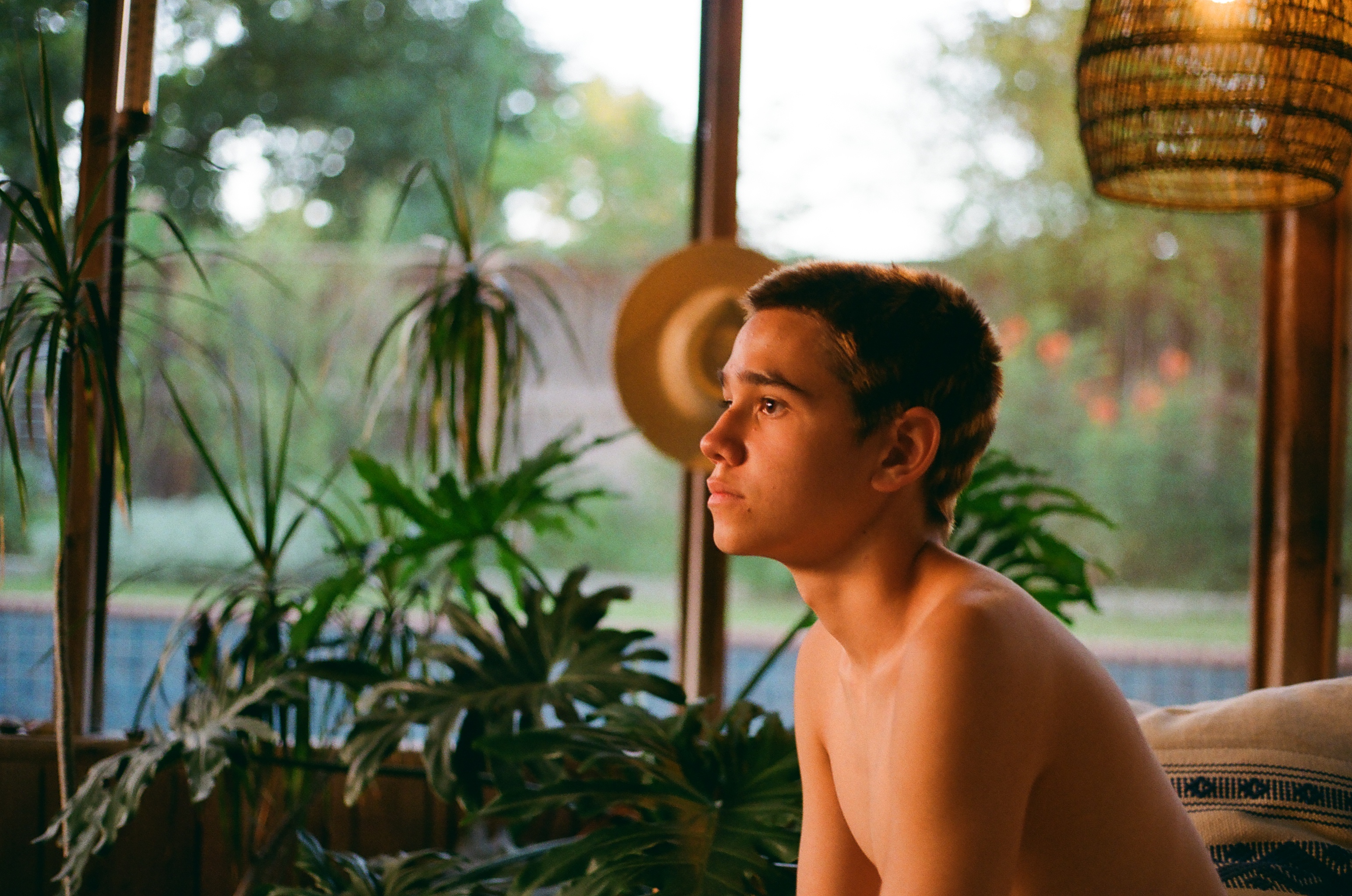 Portrait in a sunroom, backyard light behind