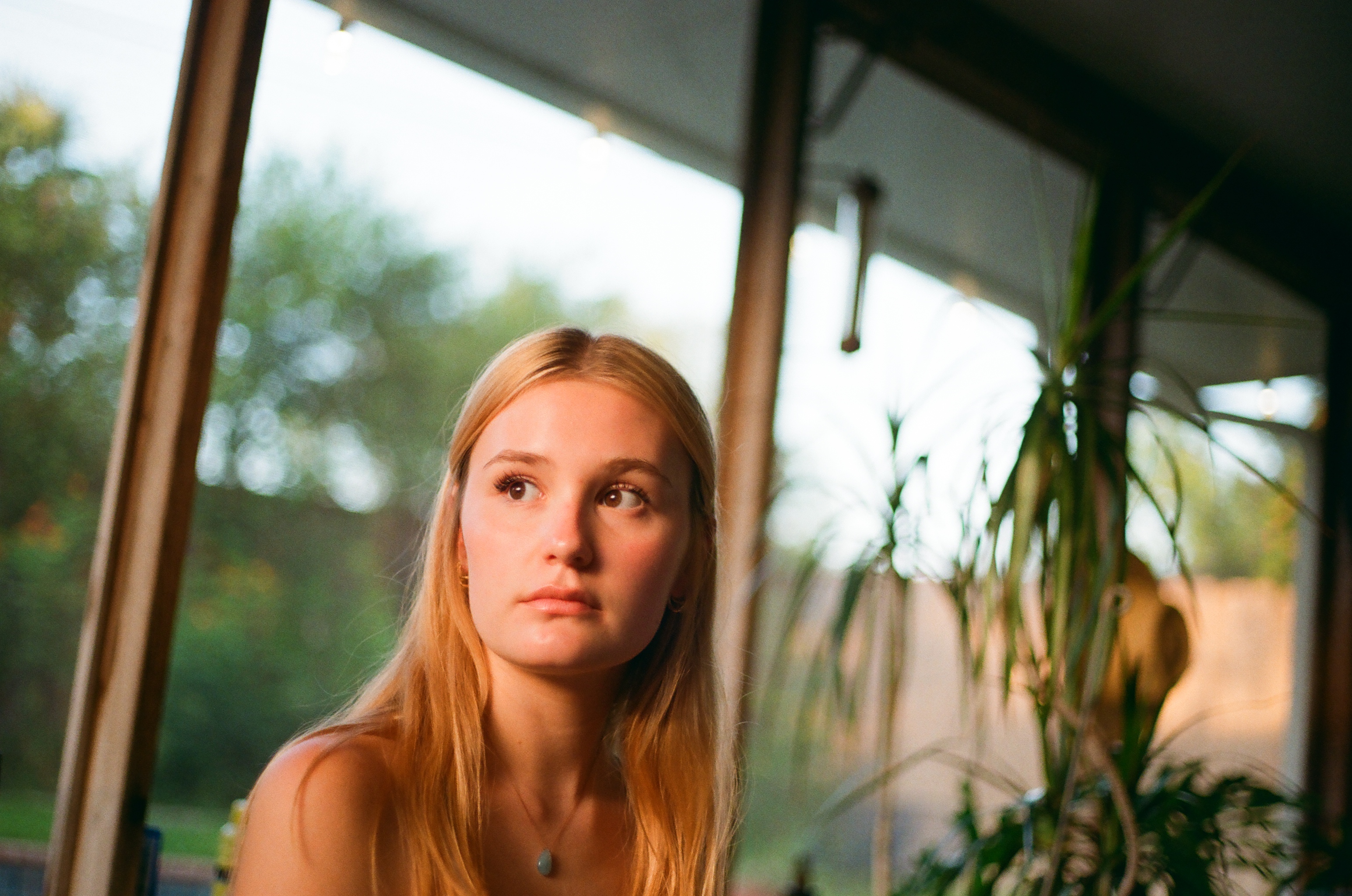 Portrait in a sunroom, backyard light behind
