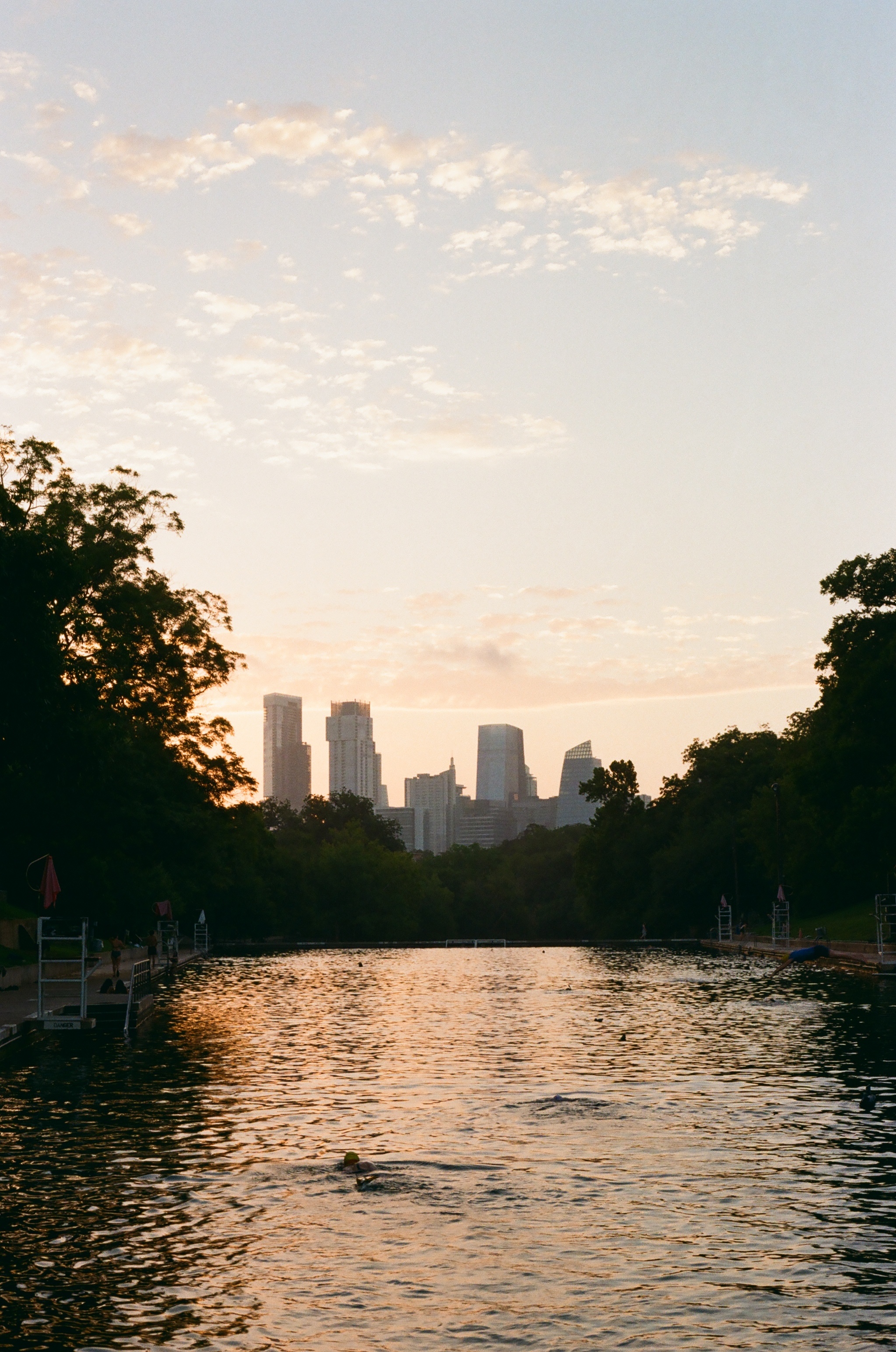 Barton Springs in early morning light, skyline in the distance